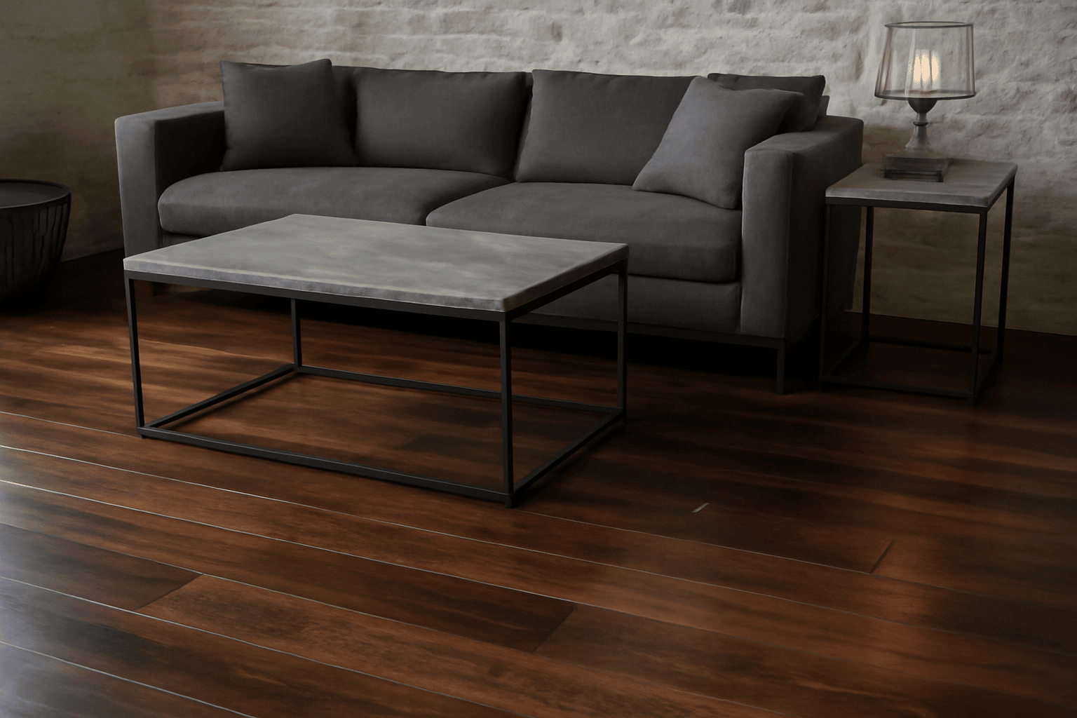 A modern living room design featuring dark wooden flooring, sleek metal-framed furniture, and a grey sofa