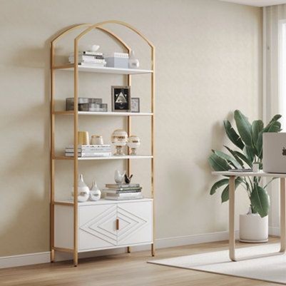 This modern home office features a gold-accented shelving unit and white cabinet for stylish storage solutions.