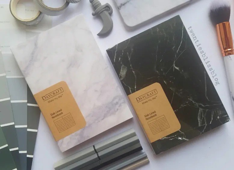 Two hardcover notebooks with marble patterns perfect for Secret Santa Gifts Under 50 AED
