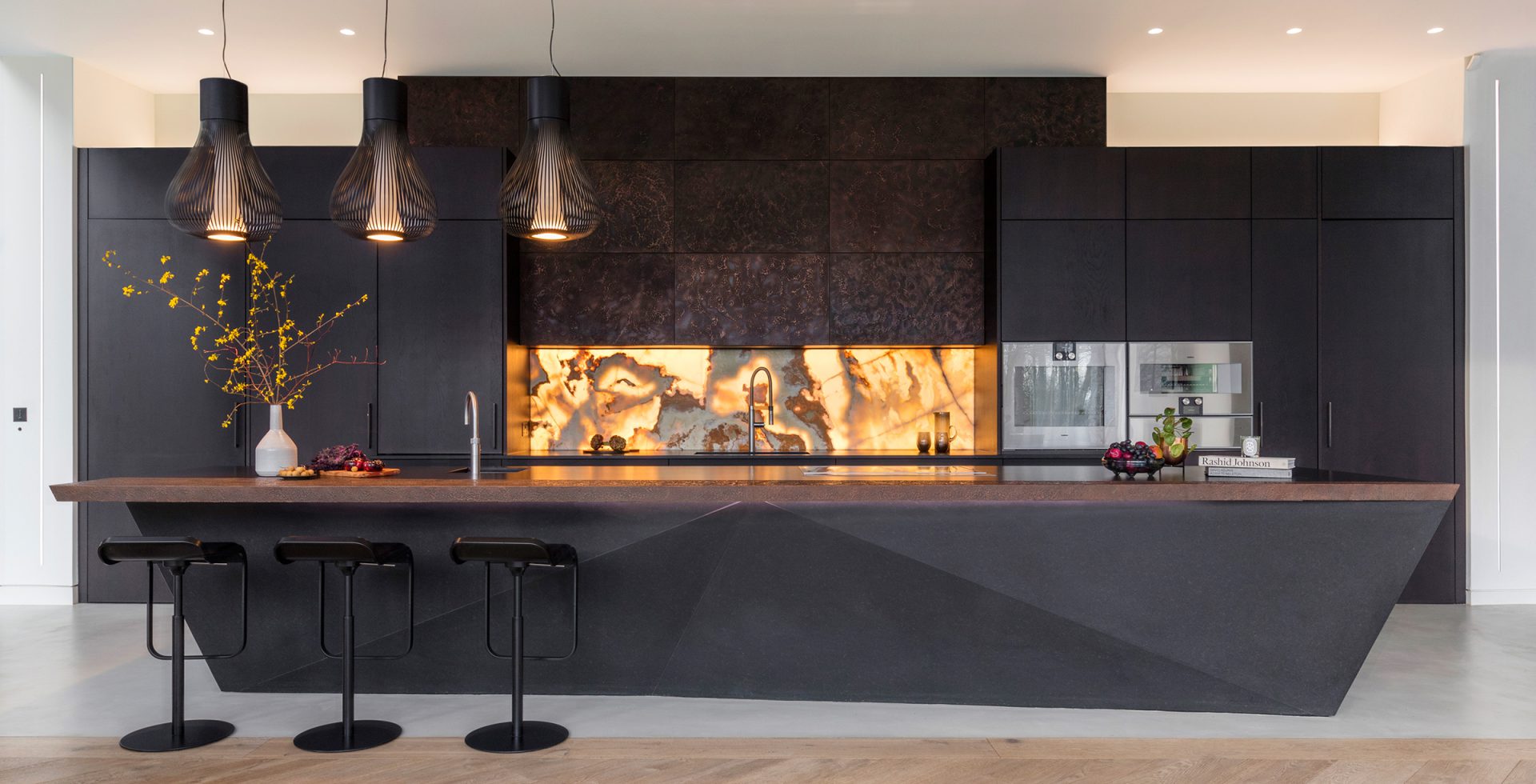 kitchen backsplash features a glowing onyx panel