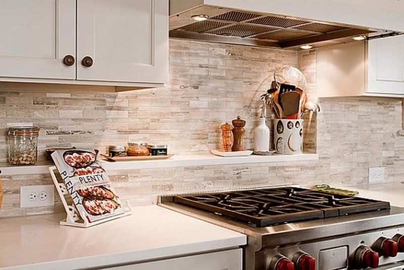 kitchen backsplash features beige travertine stone tiles