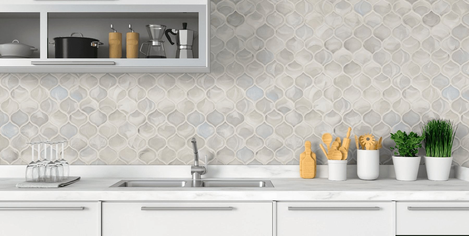 kitchen backsplash features soft patterned mosaic tiles that add texture and a light