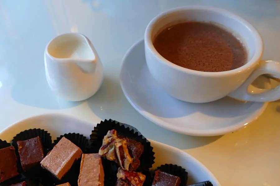 White cup of rich hot chocolate with chocolate pieces perfect for Secret Santa Gifts Under 50 AED