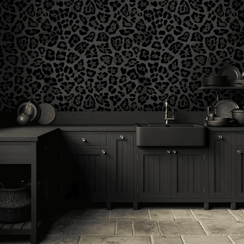black leopard print kitchen wallpaper above black cabinets and a stone floor